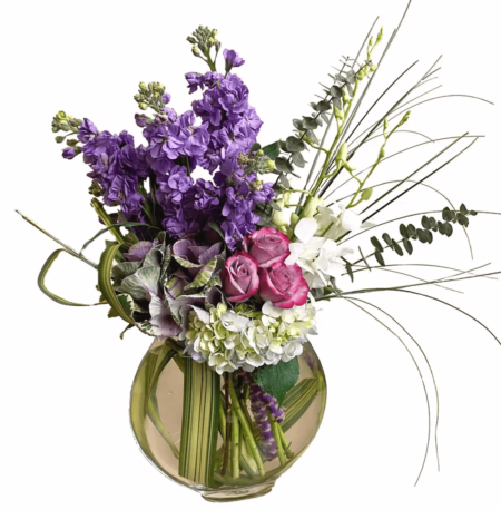 This elegant and lush custom design is perfect for an Anniversary, Birthday or any kind of celebration. This arrangement includes lush blue hydrangea, lavender kale, purple or pink roses, purple stock white dendrobium orchids.