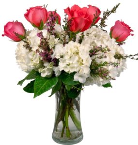  a beautiful floral arrangement of Hydrangea and Roses with a decorative keepsake heart.