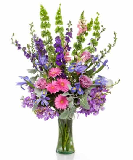 Light and airy this classic garden style vase features our freshest blooms in a cool, breezy palette of pinks and purples. Victorian Summer is one of the largest designs featured in our collection!