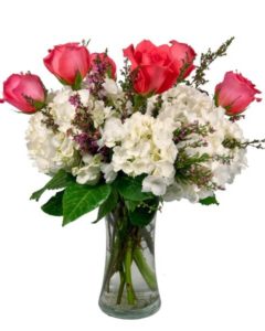 beautiful floral arrangement of Hydrangea and Roses with a decorative keepsake heart. 